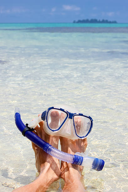 istock Man resting on the beach with snorkel mask 587510984