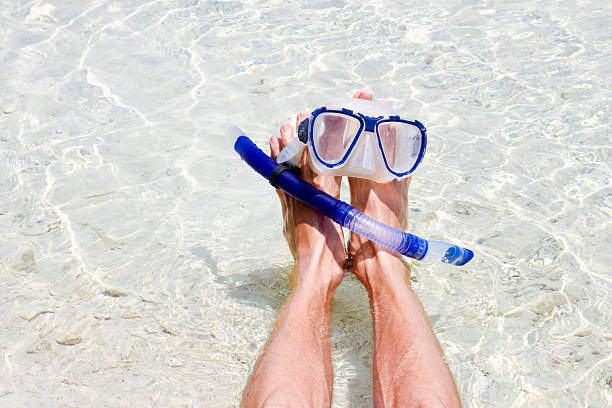 istock Man resting on the beach with snorkel mask 587511006
