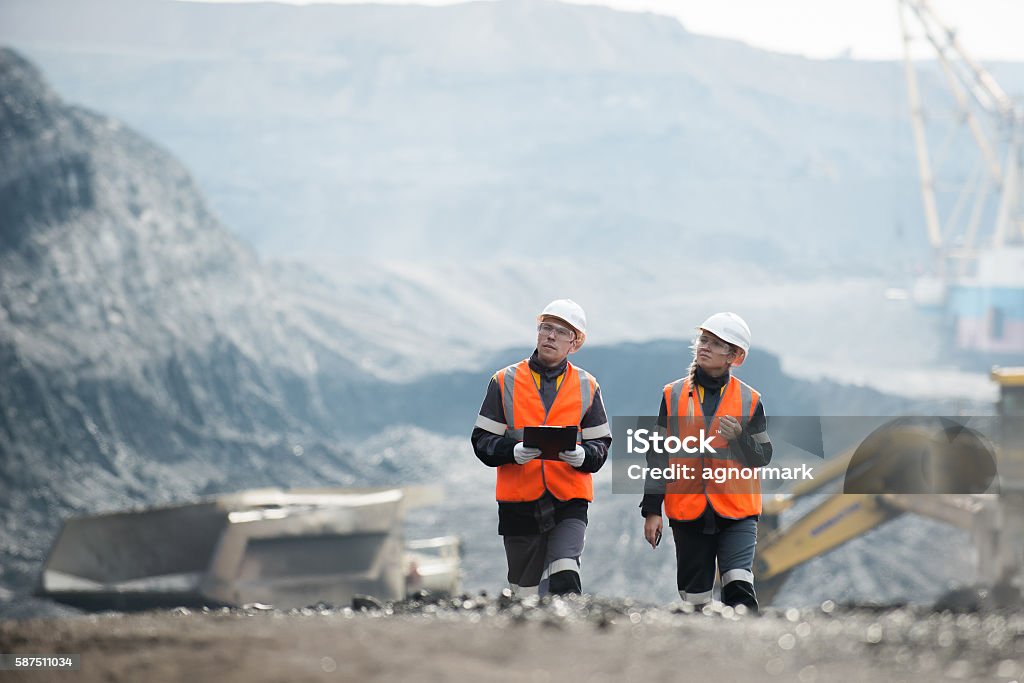 Workers with coal at open pit Two speacialists examining coal at an open pit Mining - Natural Resources Stock Photo