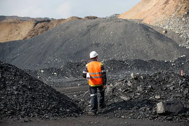 Coal mining in an open pit - Worker is looking on the huge open pit