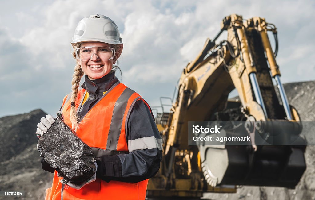 Worker with coal in the hands Young beautiful female holding a piece of coal Mining - Natural Resources Stock Photo