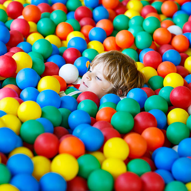 istock child playing at colorful plastic balls playground 587513430