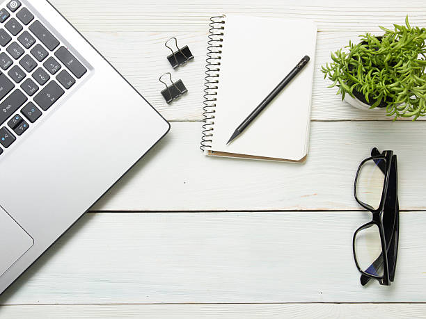 istock Office desk table with computer, supplies, flower. Top view. Copy 587514266