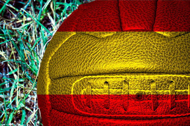 istock Spain flag over vintage football 587514408