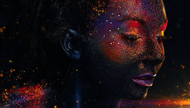 Glowing neon makeup with dramatic look Glowing neon makeup with dramatic look in his eyes. Creative body art on the theme of space and stars. Amazing close-up portrait glow in the dark makeup. body paint stock pictures, royalty-free photos & images