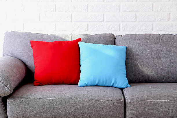 istock Colorful pillows on grey sofa on a brick wall background 587515714