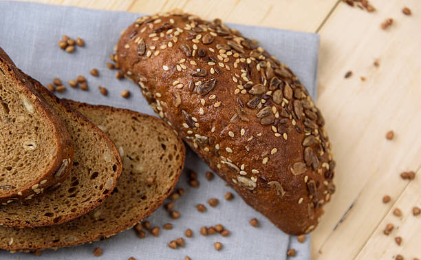 istock Fresh crusty bread on the plate and wheat ears 587515766