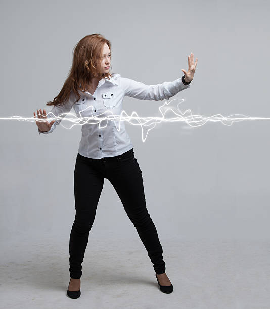 istock Woman making magic effect - flash lightning. The concept of 587518688