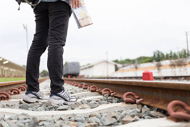 istock woman holding map with backpack at train station 587518810