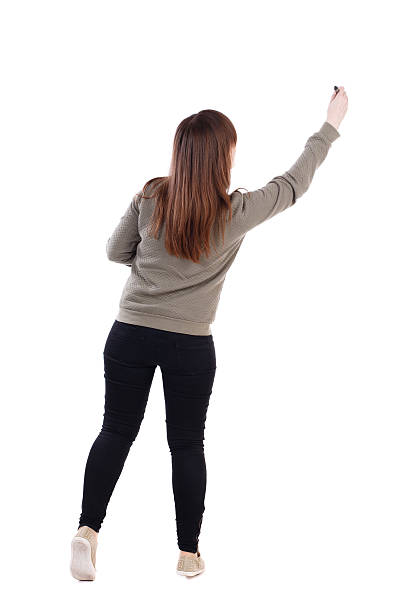 istock back view of writing beautiful woman. 587520412