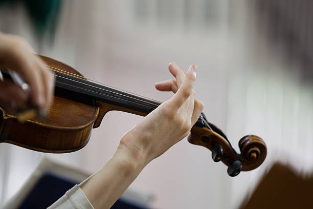 istock Hand girl playing the violin 587520576