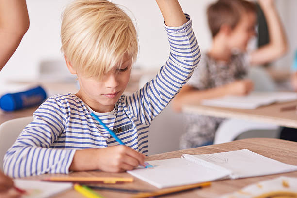 istock Boy drawing and rising his hand 587522262