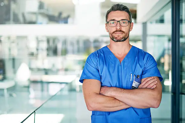 Shot of a male doctor wearing blue scrubs