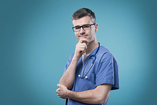 istock Smiling doctor with hand on chin 587523420