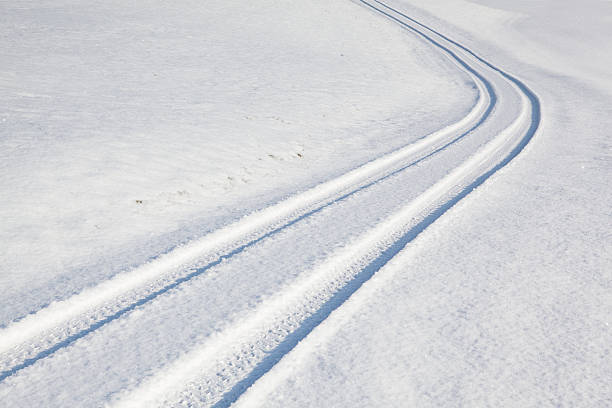 istock Car tire track on winter road 587524118