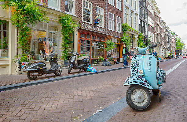 Amsterdam, Netherlands - August 1, 2016: Vintage Vespa Scooter in a street of Amsterdam. Vespa is an Italian brand of scooter manufactured by Piaggio. 