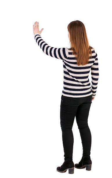 istock back view of young woman presses down on something 587525288