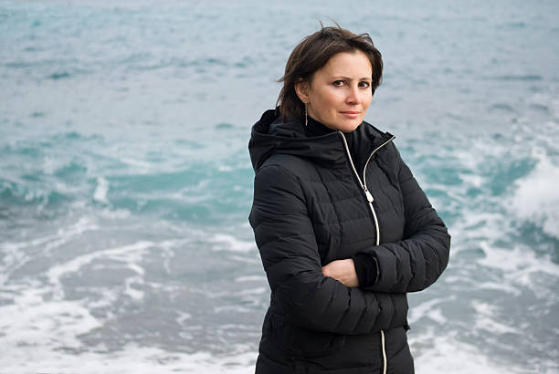 istock Woman standing front the sea 587525888