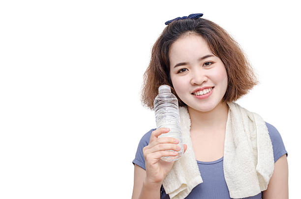 istock girl holding drinking water bottle over white 587527134