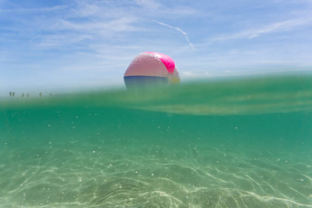 istock Beach ball on the clear sea at Pedn Vounder, Cornwall 587528376