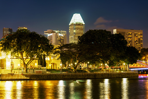 Singapore, Singapore - February 29, 2016: Singapore skyline and quay in the Downtown at night. Cityscape of  Skyscrapers illuminated with light