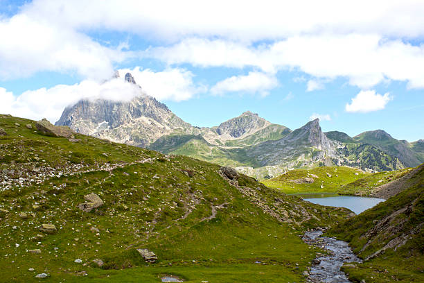 istock Midi d'Ossau peak behind another mountain and a lake 587531668