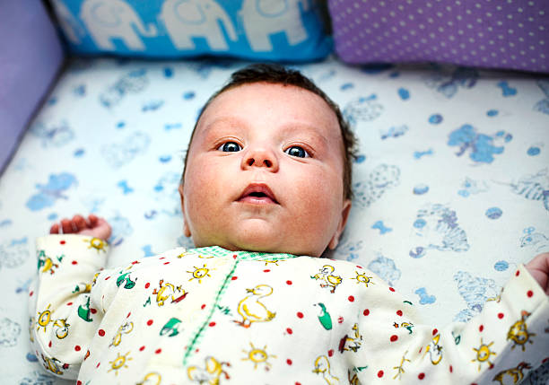 istock newborn baby lying in bed 587532776