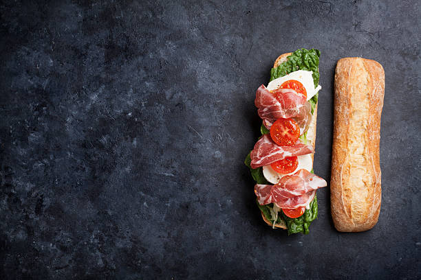 istock Sandwich with salad, prosciutto and mozzarella 587534120