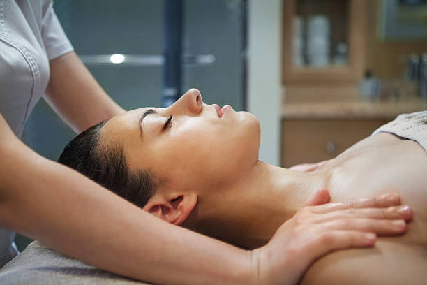 istock Masseur doing massage to woman 587534736