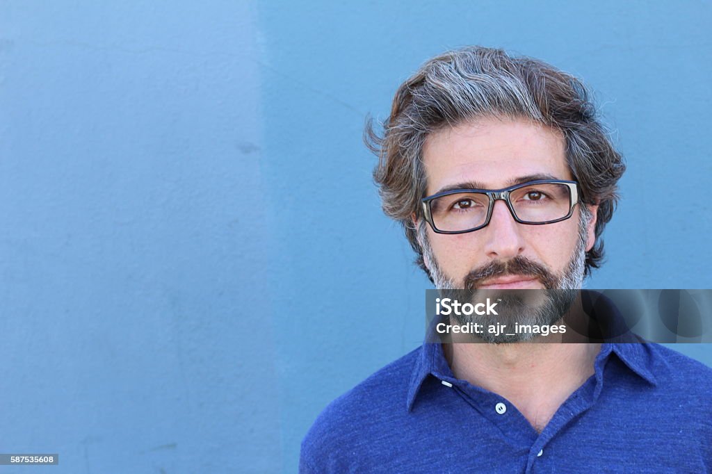 Studio portrait of a handsome business man Studio Portrait of a handsome businessman wearing glasses looking to the camera with copy space. Men Stock Photo