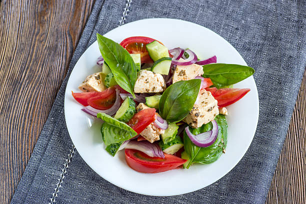 istock Fresh Greek salad on a plate, top view 587535812