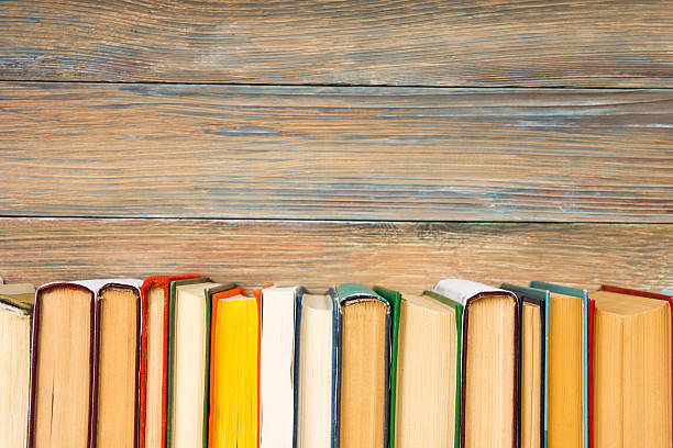 books on grunge wooden table desk shelf in library. back - success practicing book stack imagens e fotografias de stock