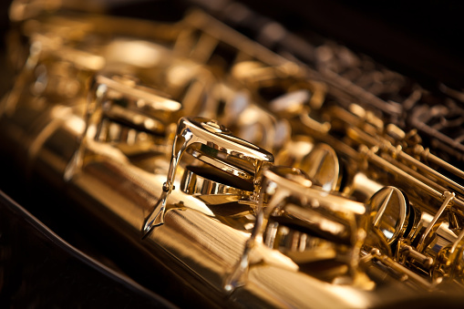 Fragment valves saxophone closeup in golden colors 