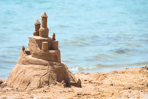 Built House sand castle on the south shore of the sandy beach blue sea