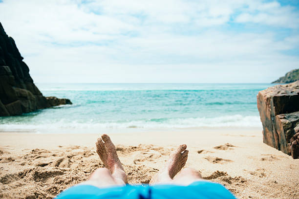 istock POV Vacation, sunbathing Pedn Vounder Beach, Cornwall 587538882