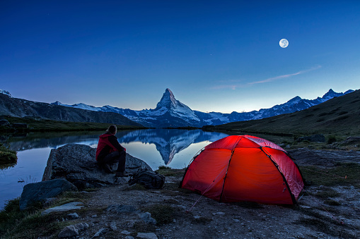 An illuminated tent  under full Moon at Matterhorn in Switzerland