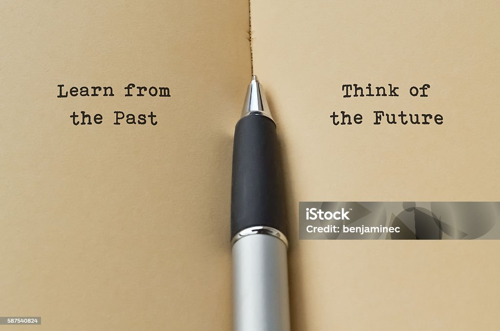 Past and Future Open book with text on both sides and a pen in the middle The Past Stock Photo