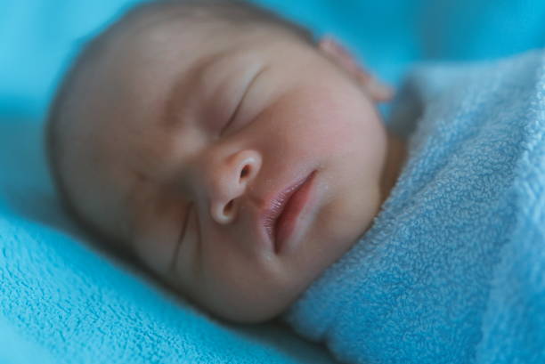 istock Newborn baby asia  while sleeping covered with blue cloth 587542462