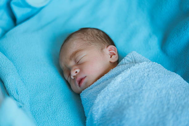 istock Newborn baby asia  while sleeping covered with blue cloth 587543170