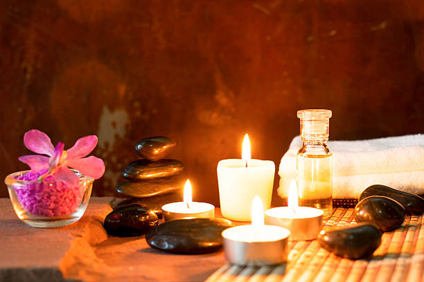 istock Spa still life with aromatic candles,orchid flower and towel. 587543396