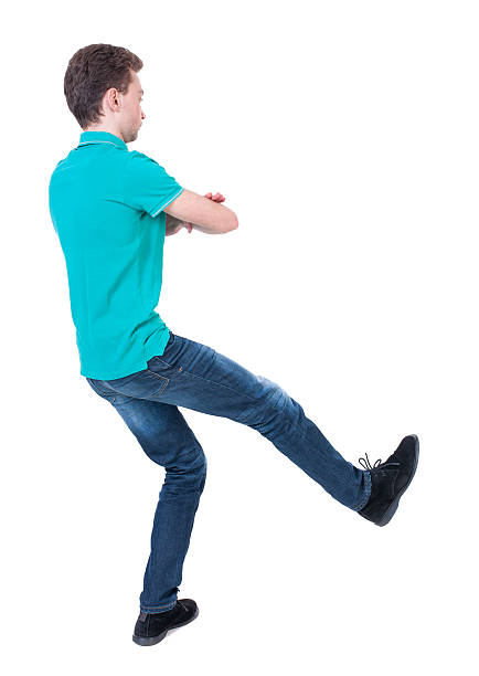 istock back view of dancing young man. 587544804