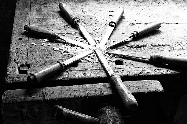 series of many sharp steel blades many chisels and sawdust chippings in an old Workbench