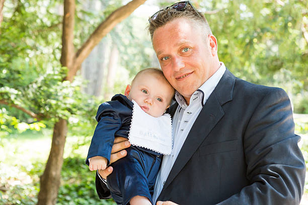 istock Baby boy is being held gently by his father 587545676