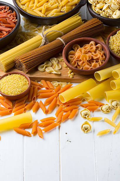 istock Differents types of pasta on the white wooden table. background 587545850