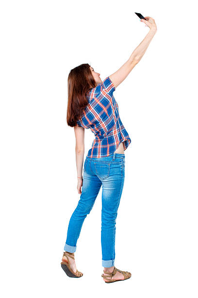 istock back view of standing young beautiful  woman  using a mobile 587545982