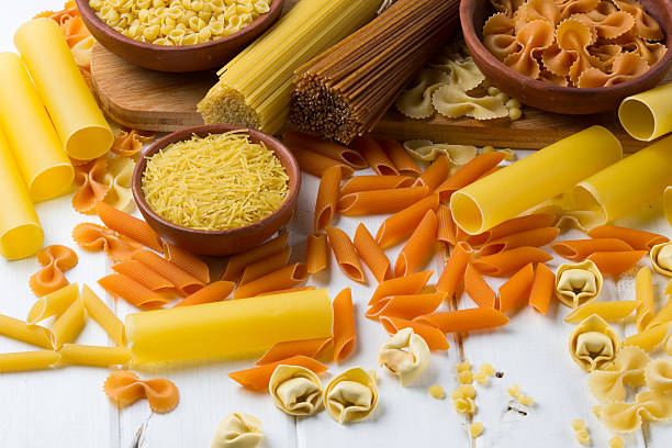 istock Differents types of pasta on the white wooden table. background 587546002