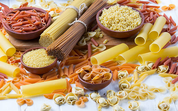 istock Differents types of pasta on the white wooden table. background 587546284