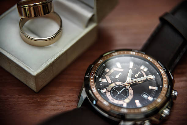 istock wedding ring in a box and watch the groom 587546852
