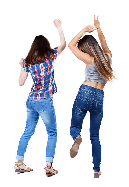 istock Back view of two dancing young women. 587547494