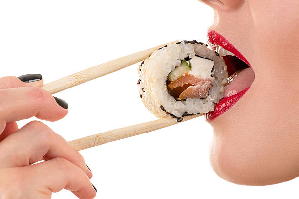 istock woman sexy eating roll 587548130